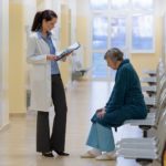 Doctor with patient in hospital corridor